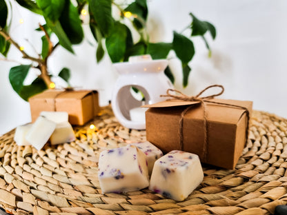 wax melts with there eco friendly packaging on a table with a wax melt burner