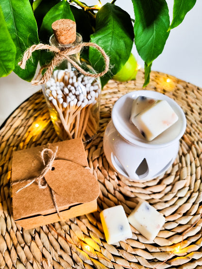 Peony scented wax melts on a table with a wax melt burner and matches 